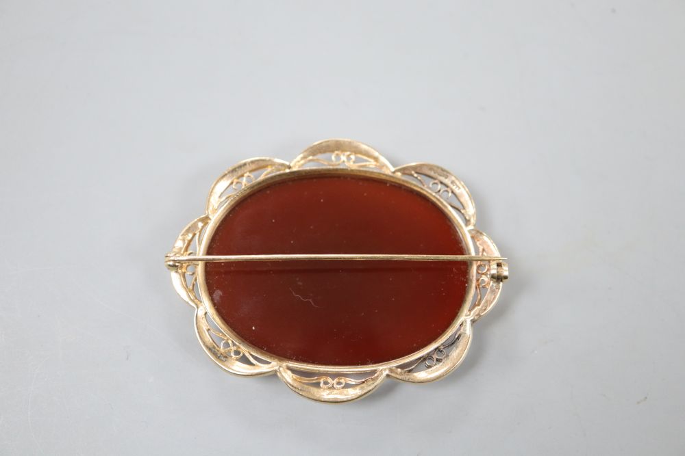 A modern 9ct gold and carnelian set oval brooch, 59mm, gross 24.9 grams.